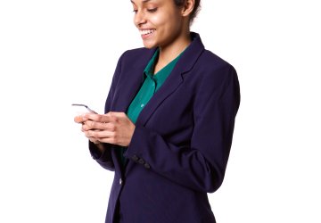 Business woman texting a message on a phone in her hands.