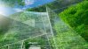 Sustainable glass office building with trees for reducing carbon dioxide.