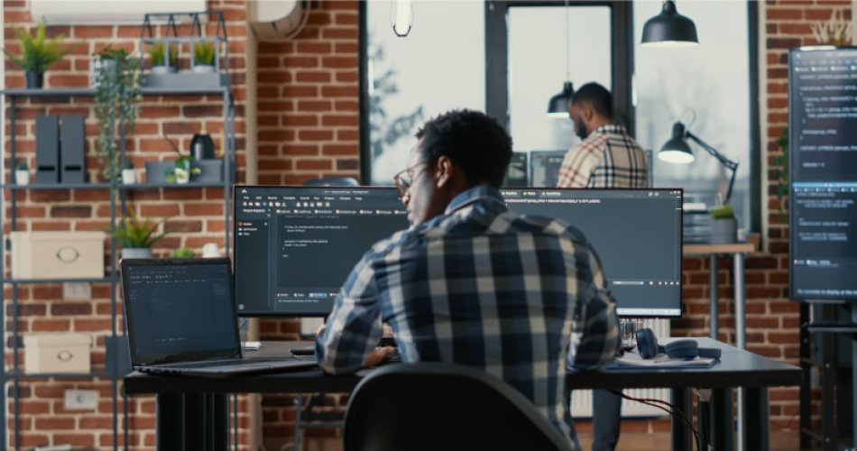 Man working behind desk on laptop