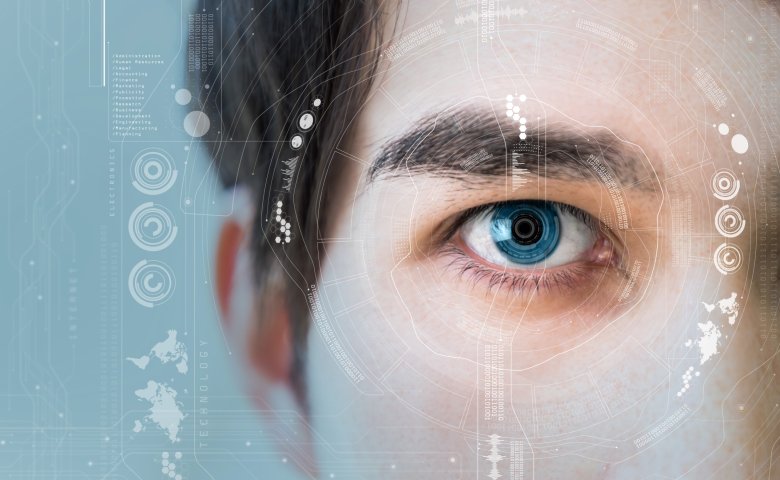 Zoom in on a man's eye with digital icons around