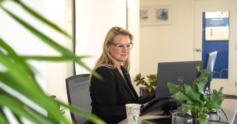 Planon employee in workspace behind a desk