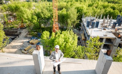 Construction site building with a engineer standing on top 