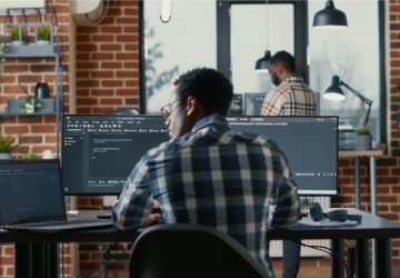 Man working behind desk on laptop