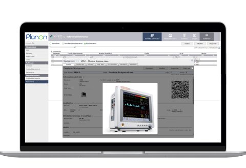 Laptop screen displaying Planon software with equipment details and a medical monitor.