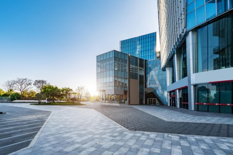 Office skyscrapers in city skyline, representing modern real estate and corporate properties.