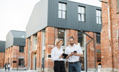 Young business colleagues in front of real estate buildings