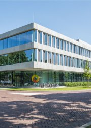 Dutch Institute for Fundamental Energy Research, a modern glass-walled building in daylight.