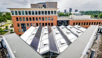 Rooftop and office buildings with solar panels and maintenance installations.
