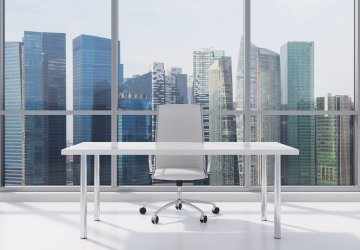 Office workplace with city skyline