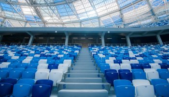 Empty chairs inside football stadium in blue and white.