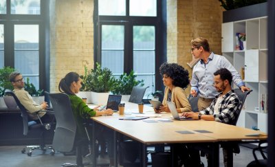 Young people around an office desk.