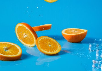 Falling orange slices on blue background.