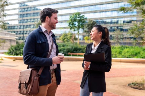 Business people close up with office building in the back