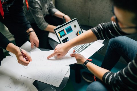 Group of people exchanging about notes and data