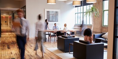 Business people at work in a busy luxury office space.