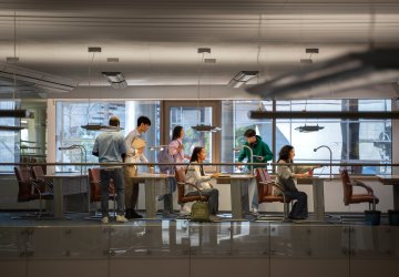 Group of students collaborating in a modern office space.