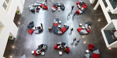 Overview of higher education students inside a university building.
