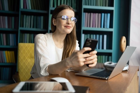 Women working on her phone and laptop
