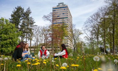 Students sitting on the grass at Radboud University