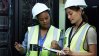 Two female maintenance engineers checking their work orders.