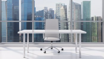 Office workplace with city skyline