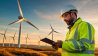 Field service worker inspecting a wind farm.
