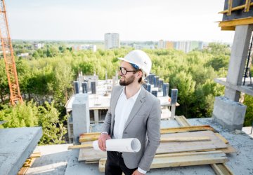 Business man on building construction site.