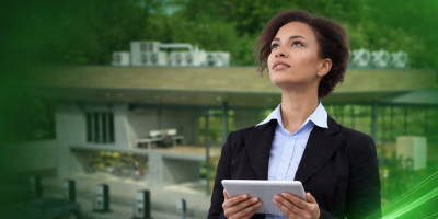 Woman with tablet on green background.