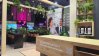 Empty Planon Real Estate exhibition stand with seating areas, digital displays and plant decorations.