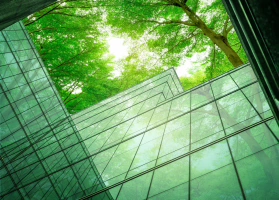 Glass building with trees on the background