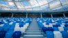 Empty chairs inside football stadium in blue and white.