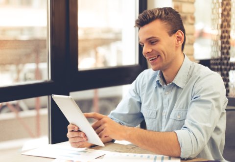 Happy man working and using tablet