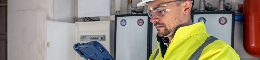 Electrical technician working on tablet