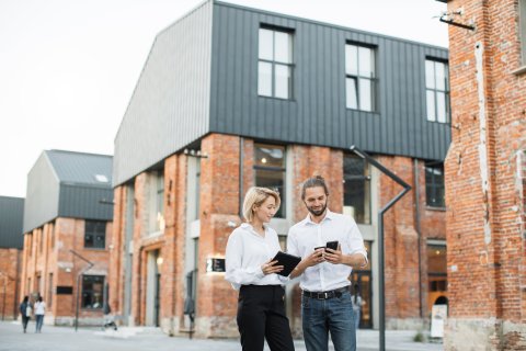 Young business colleagues in front of real estate buildings