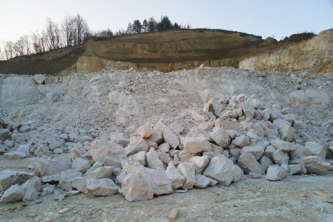 Bright gray stones next to a green field.