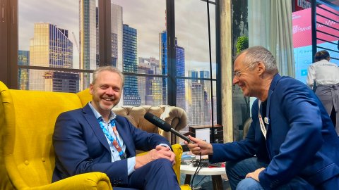 Two people sitting in front of each other conducting an interview