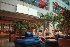 Three women sitting and talking in a clean meeting area.