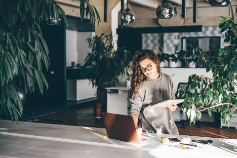 Girl working in green home office.