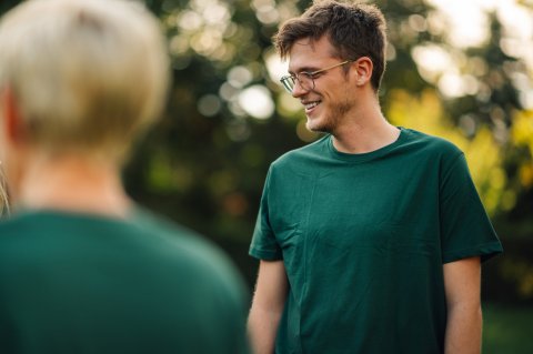 Man outside in green shirt.