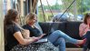 Women working on their laptops while sitting on a couch.