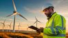 Field service worker inspecting a wind farm.