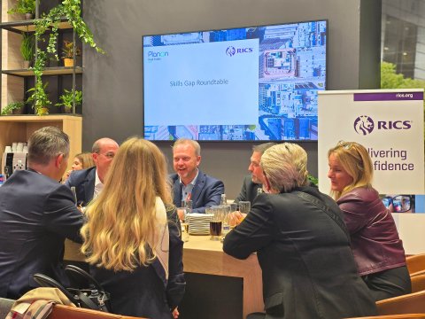 People sitting around a table, engaged in a conversation.