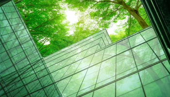 Glass building with trees on the background