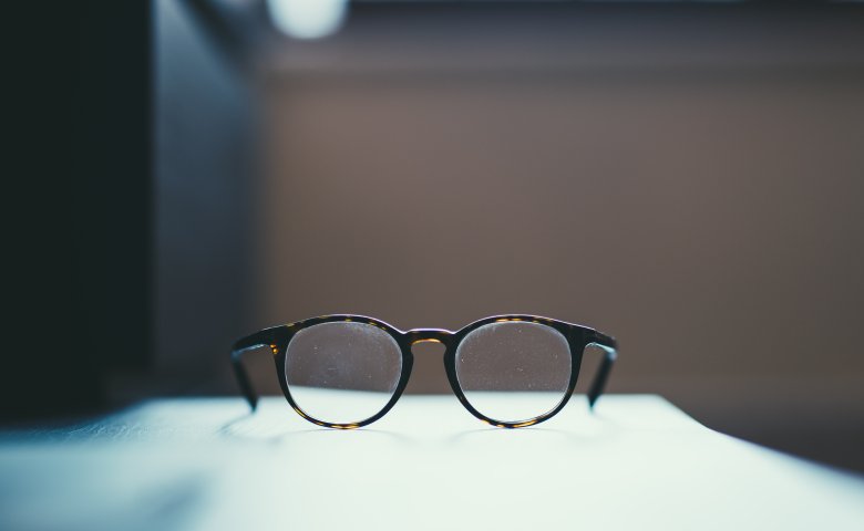 Pair of glasses in a workplace.