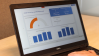 A laptop showing a dashboard with data about Covid-19 responses.