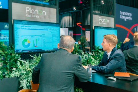 Person demonstrating software on a screen during a conversation.