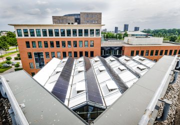 Rooftop and office buildings with solar panels and maintenance installations.