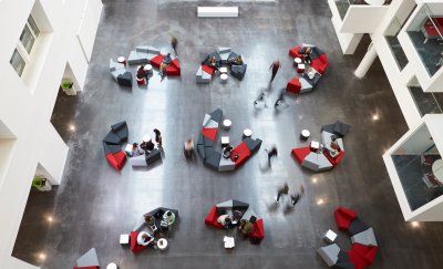 Overview of higher education students inside a university building.