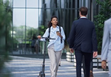 Business people walking and smiling in front of building.