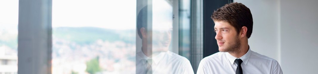 Employee staring out of window from a building